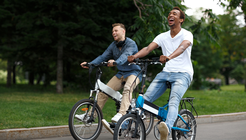 Friends riding bikes around a park
