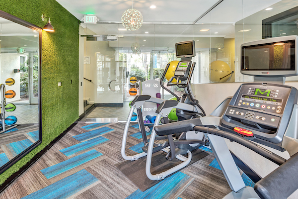 Fitness center with cardio and strength training equipment.