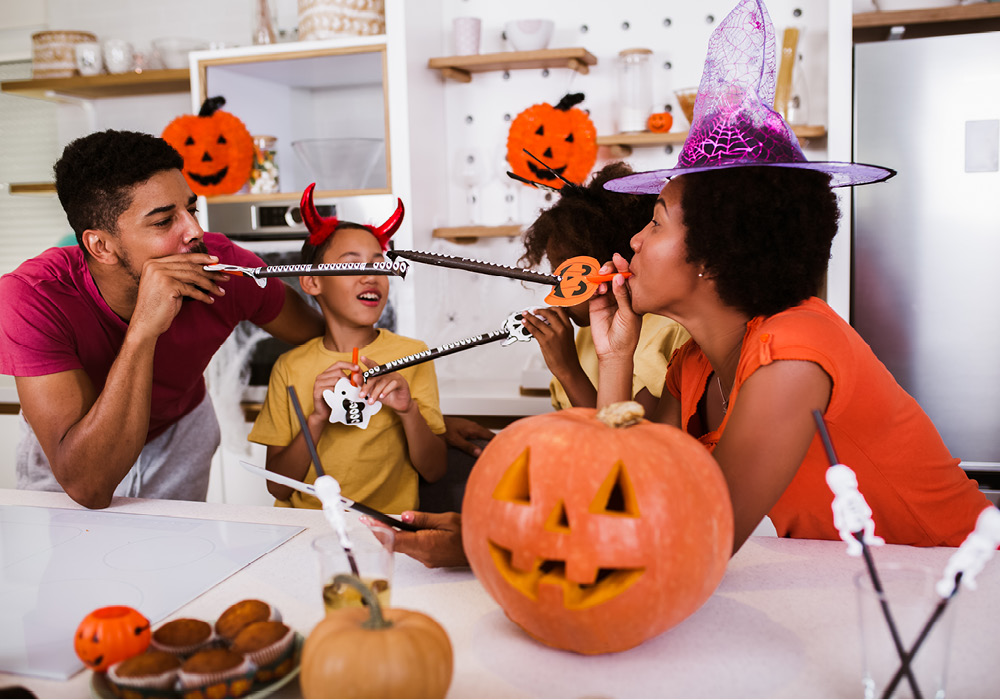 Family of four celebrating Halloween in their apartment home.
