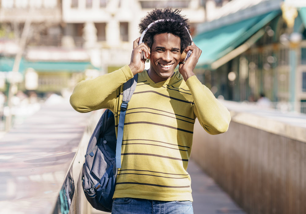 Man listening to new music on his headphone.