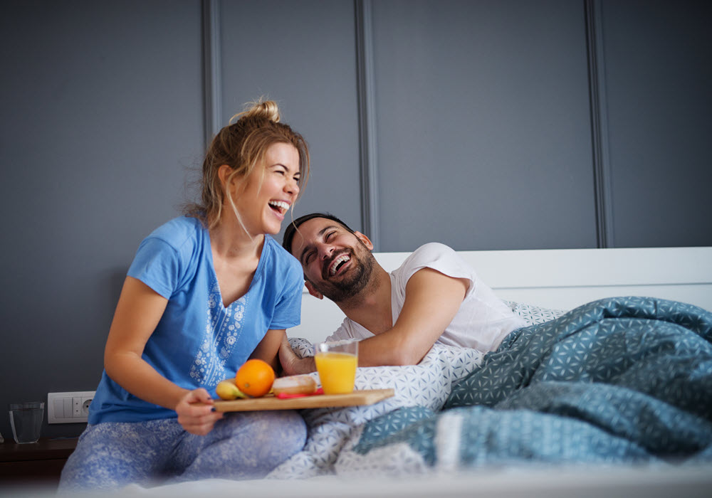 Couple having a Valentine's Day breakfast in bed.