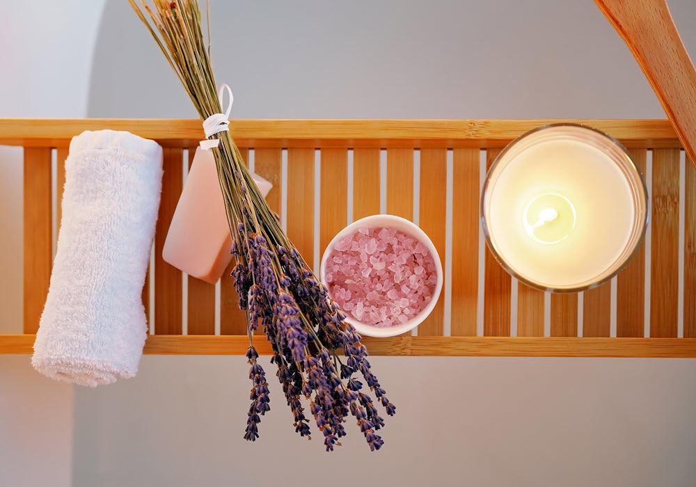 Fresh bath towel, lavender, bath salts, and a candle