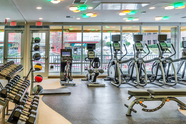Fitness center with cardio and strength training equipment.