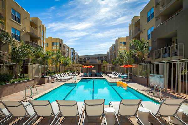 Outdoor swimming pool surrounded by lounge chairs.