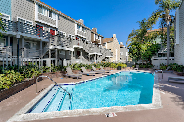 Clubhouse with hardwood style flooring, pool table, lounge seating, and TV.