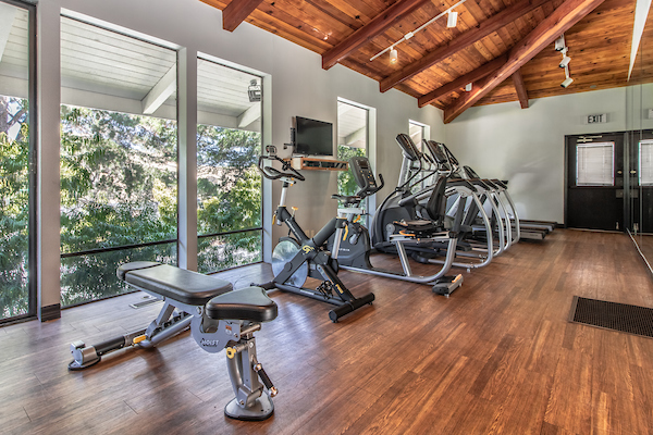 Fitness center with cardio and strength training equipment.