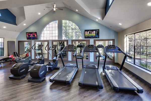 Fitness center with cardio and strength training equipment.