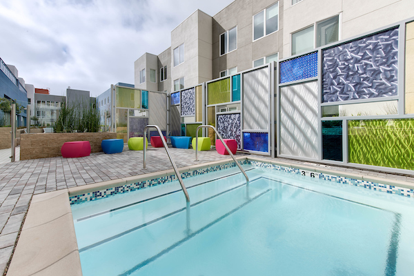 Outdoor swimming pool area with lounge chairs.