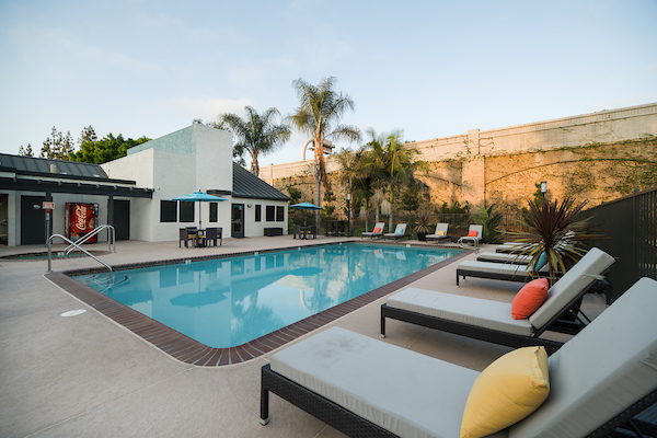 Outdoor swimming pool area with lounge seating.