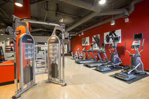 Fitness center with cardio and strength training equipment.