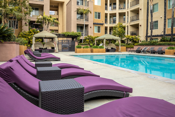 Outdoor swimming pool area with lounge seating.