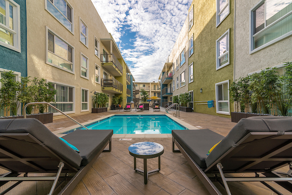 Outdoor swimming pool area with lounge seating.