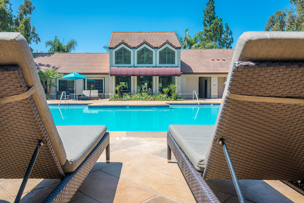 Outdoor swimming pool area with lounge seating.