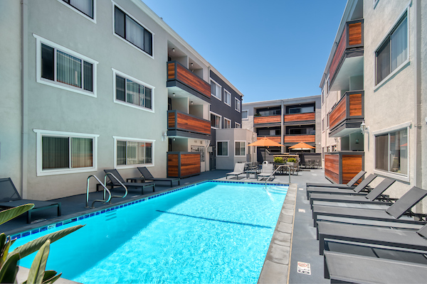 Outdoor swimming pool area with lounge seating.