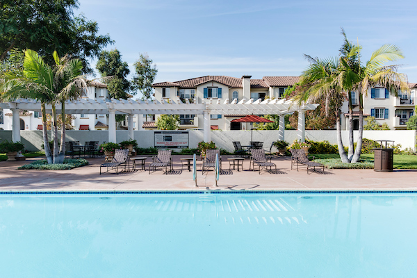 Outdoor swimming pool surrounded by lounge chairs.