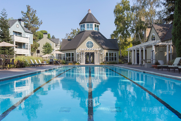 Outdoor swimming pool area with lounge seating.
