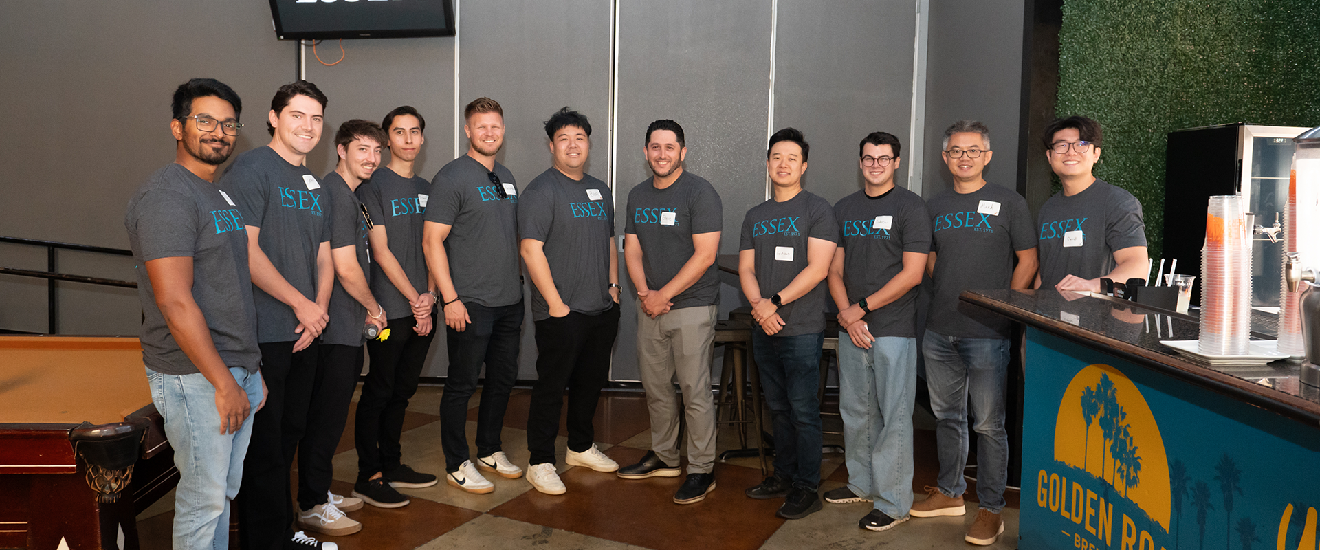 Happy Essex employees sporting company gear while enjoying a company employee appreciation event