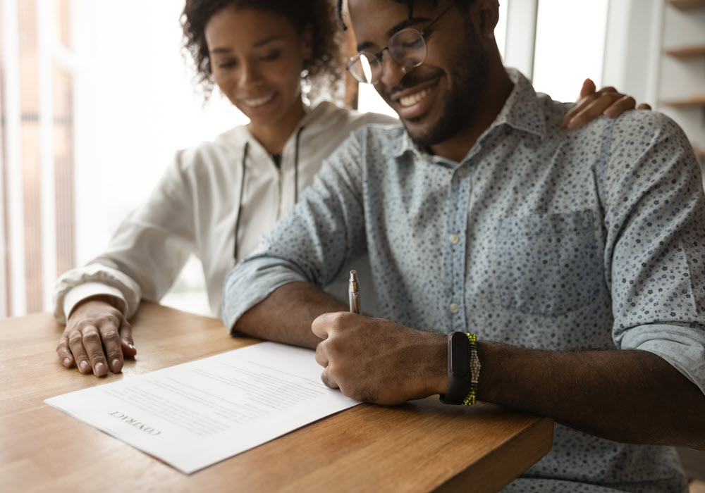 A couple signing a leasing contract.