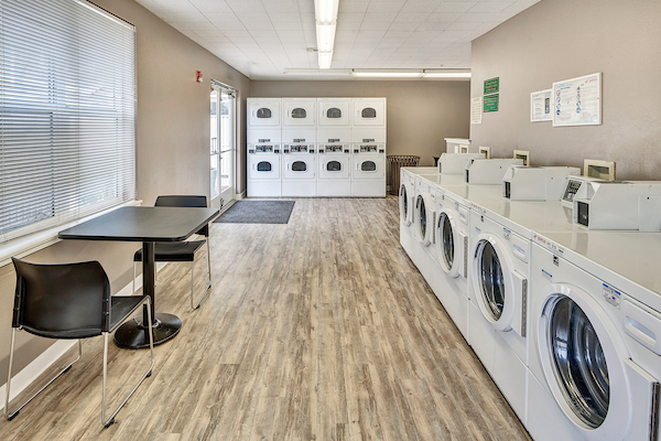 Onsite laundry room with five washers and eight dryers.