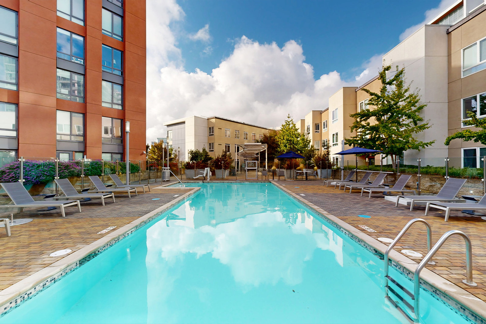 Outdoor swimming pool area with lounge chairs.