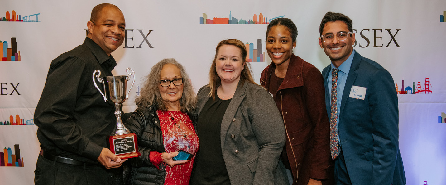 Diverse group of people receiving company awards.